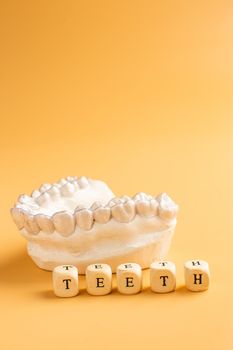 Close-up individual tooth tray Orthodontic dental theme. In hand Invisible braces