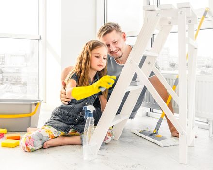 Preschool cute girl help her dad to do cleaning chores at home