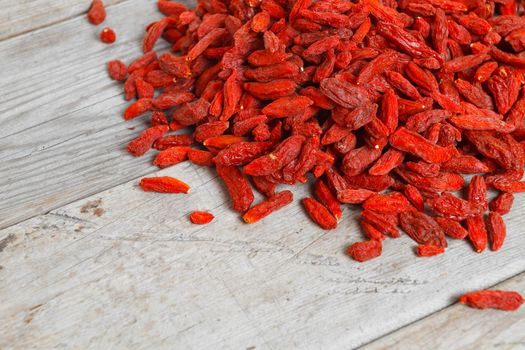 Tibetan goji berries on a wooden table, top view