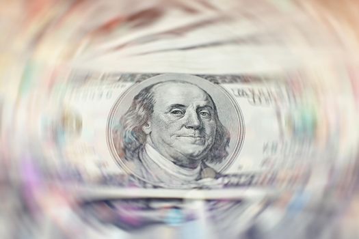 A stack of money. Heap of one hundred dollar bills on money background. Fake money. Shallow depth of field. Selective focus.