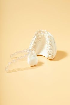 Orthodontic dental theme on  yellow background.Transparent invisible dental aligners or braces aplicable for an orthodontic dental treatment