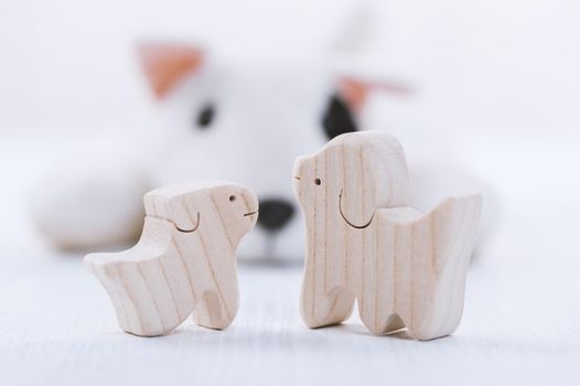 cute wooden toy animal on white wood board, tiny toys and shallow depth of field
