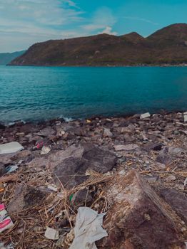 Environmental disaster, ecological pollution, garbage scattered on the ground waste near sea. Problem of contamination of the environment. Planet ecology. Unauthorized dump of garbage outdoors.