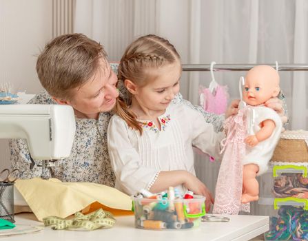 cute little girl and her dad in a sewing workshop