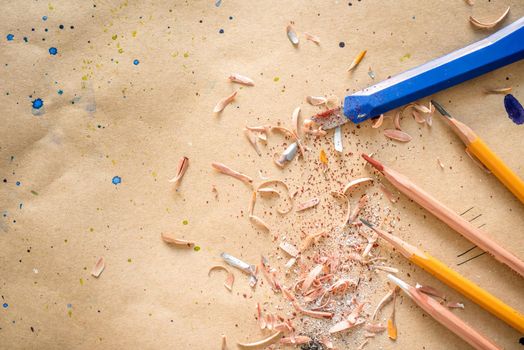 Manually sharpened pencils with office cutter on workshop table, with text space