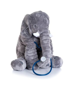 cute fluffy elephant doll with stethoscope as a doctor isolated over white background