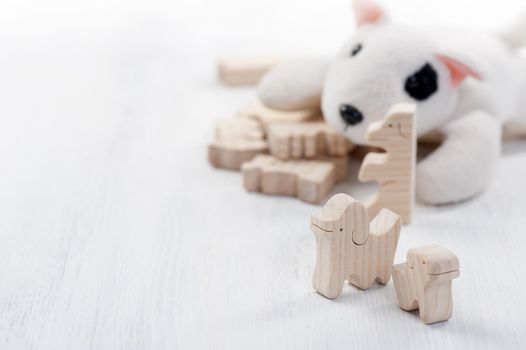 cute wooden toy animal on white wood board, tiny toys and shallow depth of field