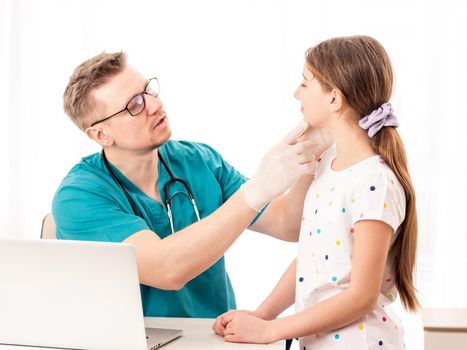 Professional physician looks closely at sick patient, on white background