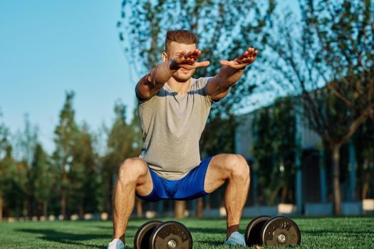 male athlete park with dumbbells doing CrossFit exercise. High quality photo