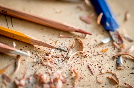 Close-up of graphite graphic pencils with wooden chips, soft focus