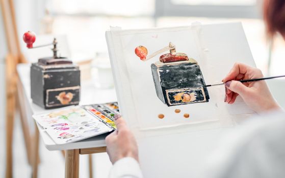 Woman drawing on white canvas old music box from natute with watercolor