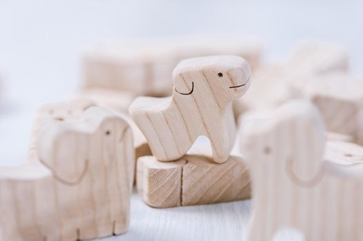 cute wooden toy animal on white wood board, tiny toys and shallow depth of field