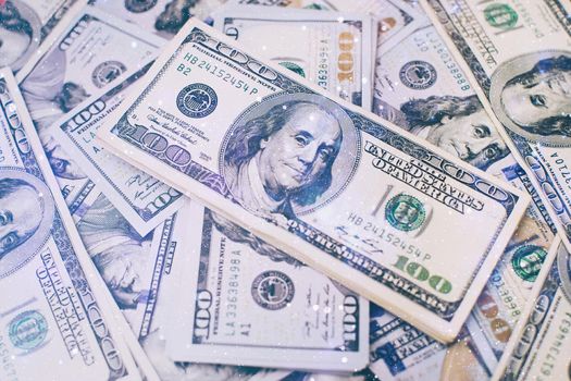 A stack of money. Heap of one hundred dollar bills on money background. Fake money. Shallow depth of field. Selective focus.