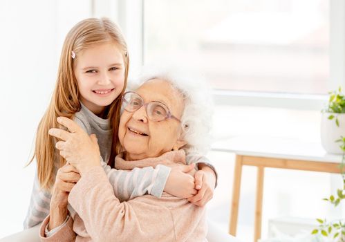 Lovely granny with granddaughter in light room