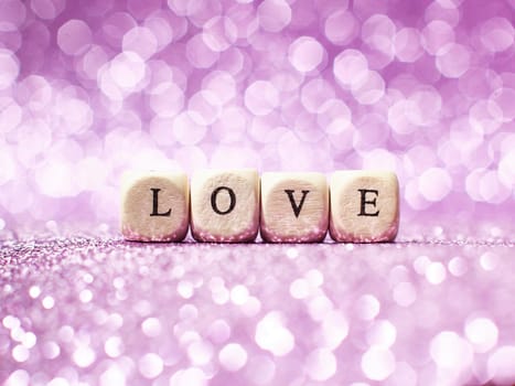 Lettering Love bright glitter lights bokeh background .