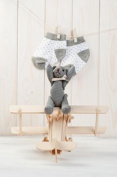 Cute teddy bear on wooden background with wooden baby toys