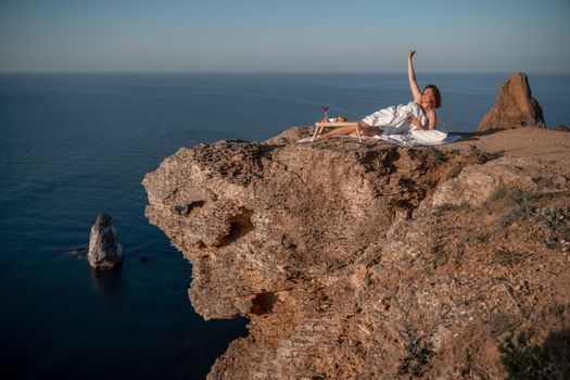 Woman wearing pajamas wake up in bed wuth duvet and pillow over nature sea background outdoors. Back view. Good morning. Freedom concept