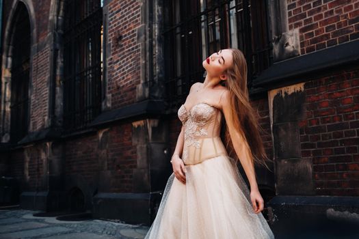A bride in a wedding dress with long hair in the old town of Wroclaw. Wedding photo shoot in the center of an ancient city in Poland.Wroclaw, Poland.