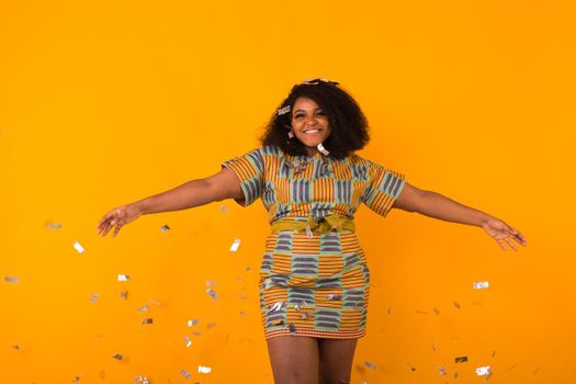 Celebrating happiness, young woman dancing with big smile throwing confetti