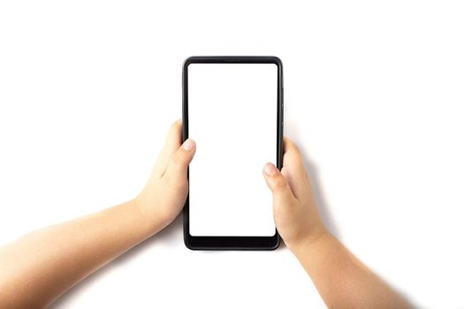 The phone is in the hands of the child. Close up hand holding black phone white screen. Isolated over white background Mobile phone frameless design concept.