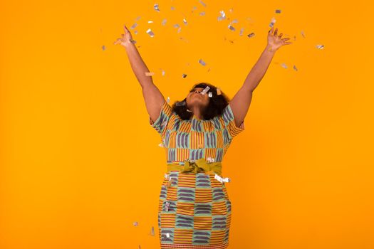 Celebrating happiness, young woman dancing with big smile throwing confetti