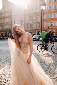 A bride in a wedding dress with long hair in the old town of Wroclaw. Wedding photo shoot in the center of an ancient city in Poland.Wroclaw, Poland.