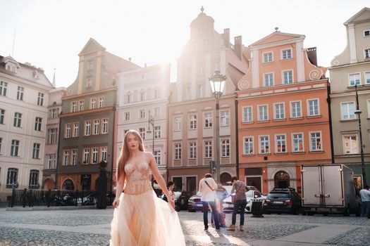 A bride in a wedding dress with long hair in the old town of Wroclaw. Wedding photo shoot in the center of an ancient city in Poland.Wroclaw, Poland.