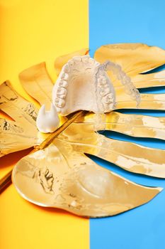 Orthodontic dental theme on blue and yellow background.Transparent invisible dental aligners or braces aplicable for an orthodontic dental treatment