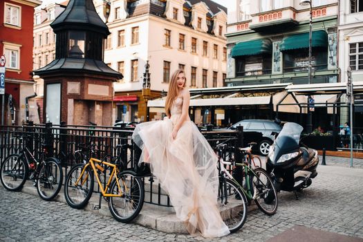 A bride in a wedding dress with long hair in the old town of Wroclaw. Wedding photo shoot in the center of an ancient city in Poland.Wroclaw, Poland.