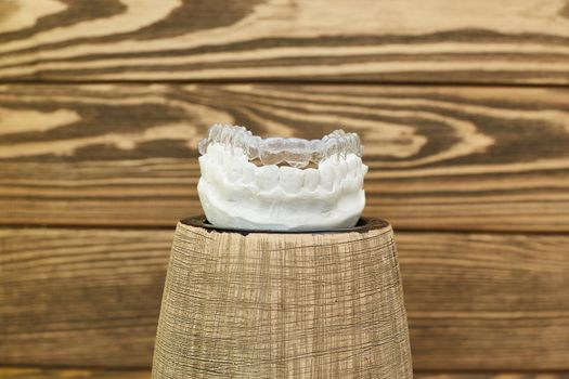 Orthodontic dental theme on a rustic background. Transparent invisible trays or braces for orthodontic dental treatment.