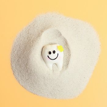 Smile of a tooth in the sand, healthcare, love, family dentist, world day of teeth, world day of health, wellbeing,
