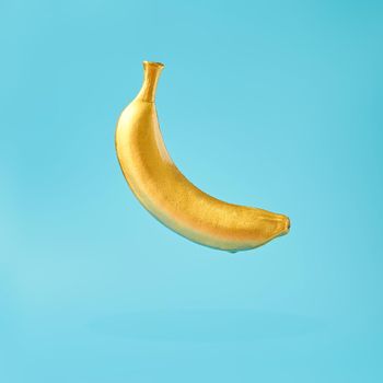 Trendy sunlight Summer  yellow banana  on bright light blue background. Minimal summer concept.