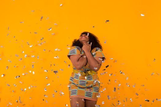 Celebrating happiness, young woman dancing with big smile throwing confetti