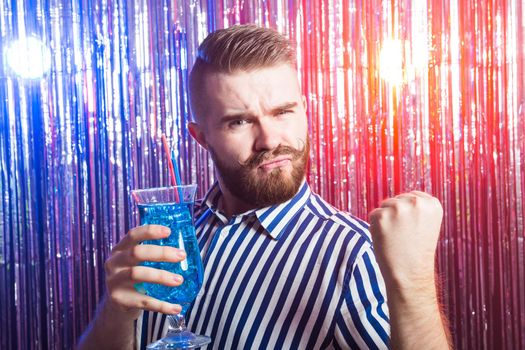 Alcoholism, fun and fool concept - Drunk guy at party in a nightclub