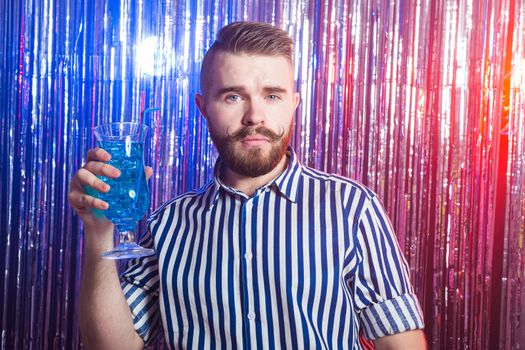 Alcoholism, fun and fool concept - Drunk guy at party in a nightclub