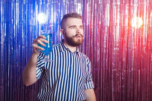 Alcoholism, fun and fool concept - Drunk guy at party in a nightclub