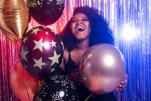 Portrait of a beautiful african american woman against twinkling background. Birthday party, nightclub and nightlife.