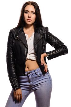 Young fashion brunette woman in black leather jacket posing isolated on white background