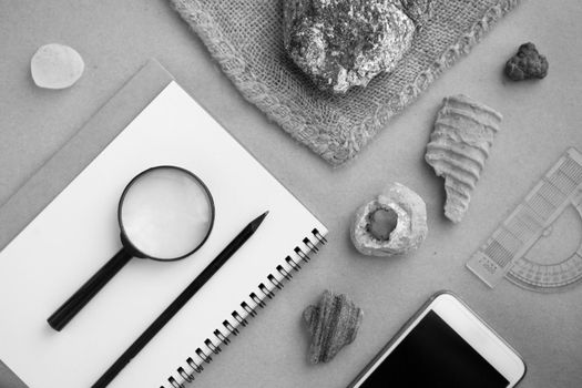 Stone samples, loop, notebook and mobile phome at geological laboratory. Geology rock laboratory. Laboratory for analysis of geological soil materials, stones, minerals, rocks samples for researchers