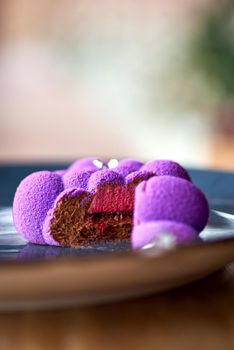 French Mousse Mini Desserts with Purple Velvet Cover on the table, serving in a restaurant, menu food concept.