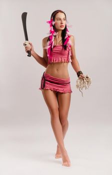 the slender girl in a local Amazon costume with a machete in her hands