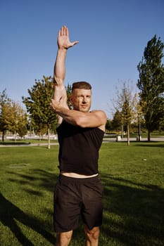 beefy man and athlete in the park during summer workout. High quality photo