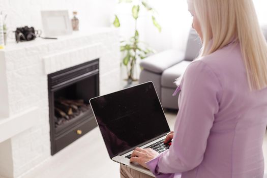 Woman using laptop indoor.close-up hand