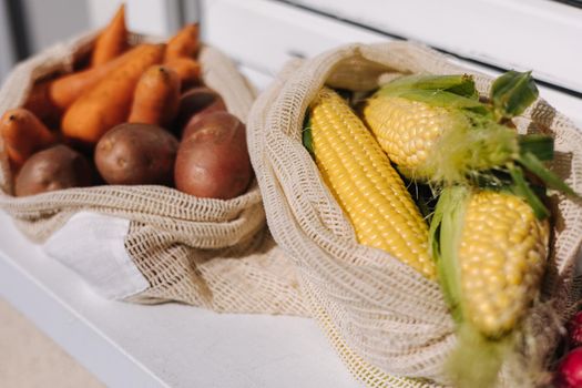 Fresh raw corn in eco canvas grocery bag. Cotton bags with vegetables. Zero waste shopping concept. Plastic free items.
