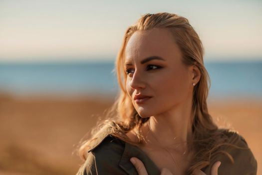 Profile portrait of a young beautiful blonde with loose hair on the beach