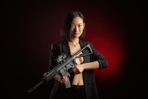 the asian woman in a jacket with an automatic rifle in her hands mafia fighter