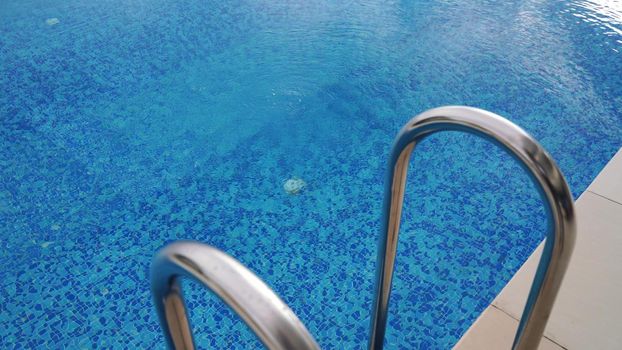 Close-up of the movement of many air bubbles floating on the surface of the water in the pool. Beautiful underwater background