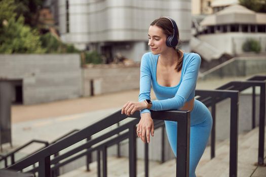 happy beautiful caucasian woman at workout in urban city