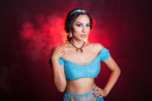 Portrait of a young woman in the image of an Eastern fairy Princess on dark background