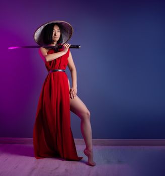 the portrait of an Asian woman in a red cape and an Asian hat with a katana in her hand image of a samurai